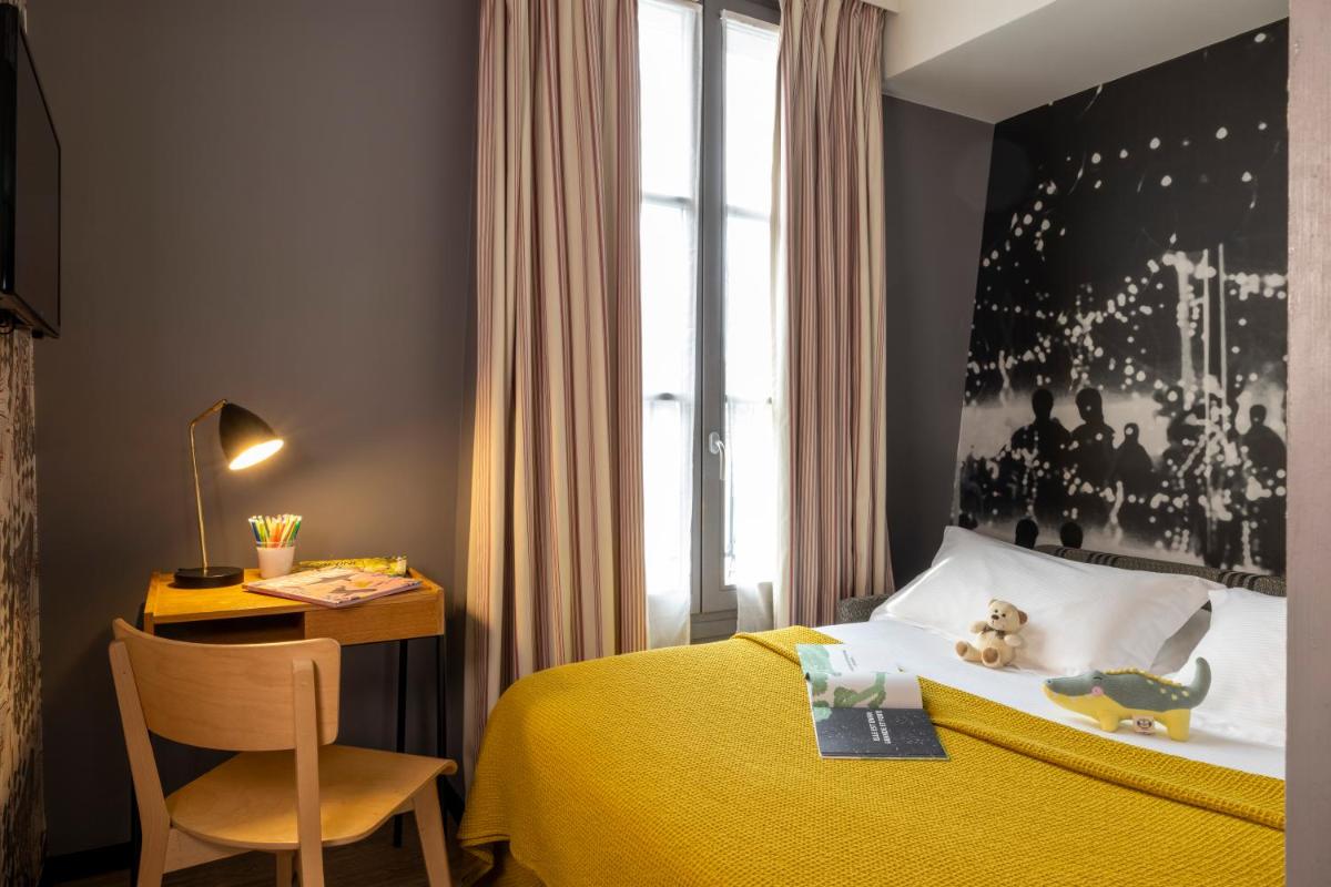 Un ou plusieurs lits dans un hébergement de l'établissement Hotel L’Antoine