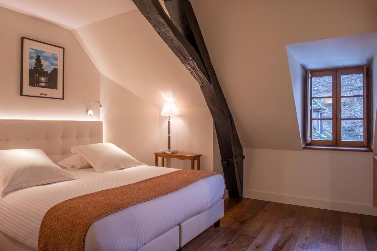 Un ou plusieurs lits dans un hébergement de l'établissement L'Hôtel