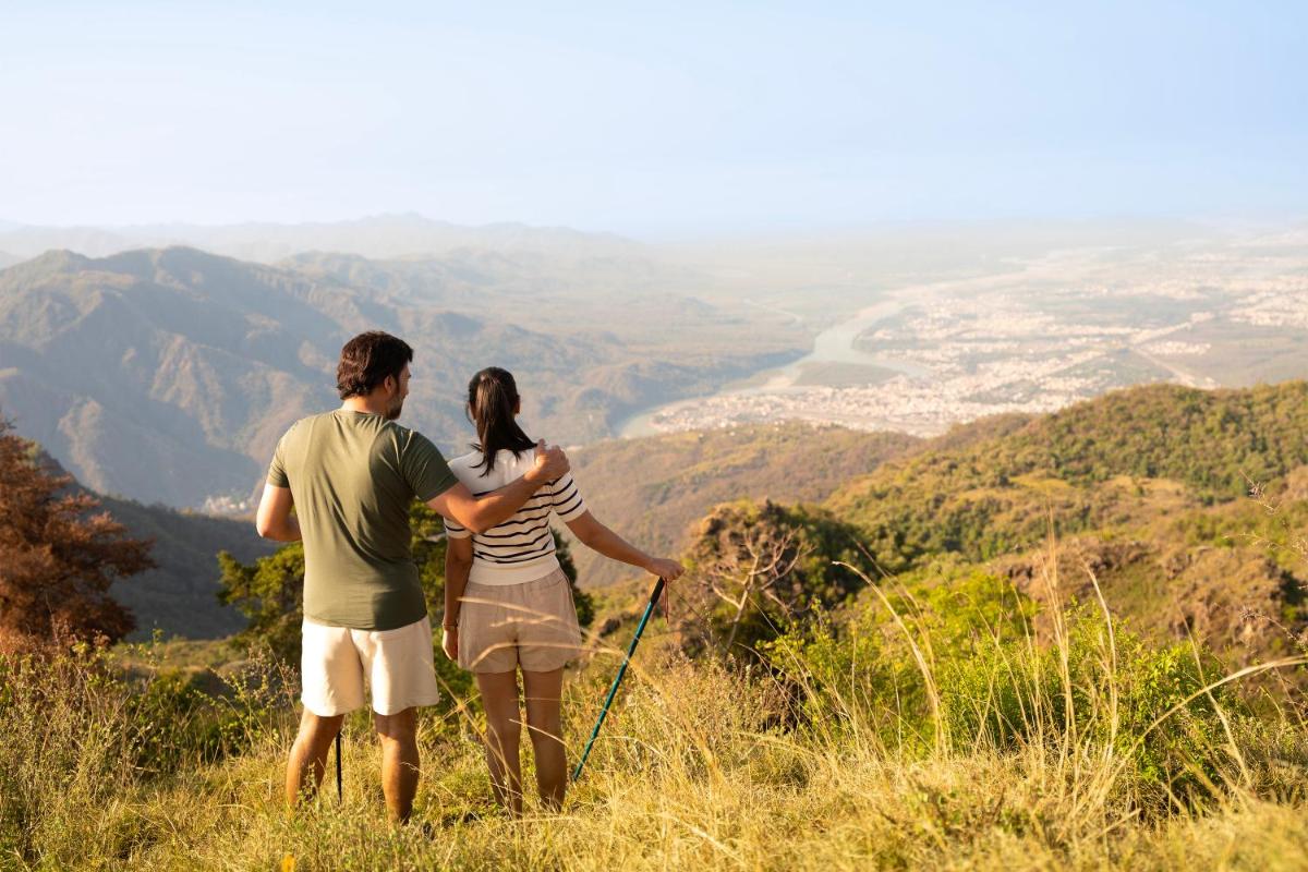a man and woman standing on top of a mountain at The Westin Resort & Spa Himalayas in Rishīkesh