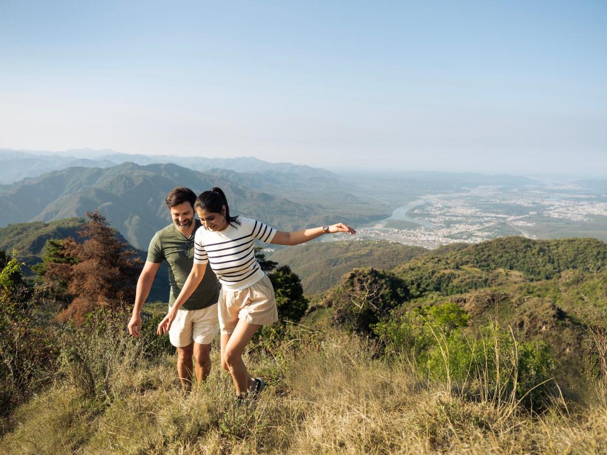 a man and woman standing on top of a hill at The Westin Resort & Spa Himalayas in Rishīkesh