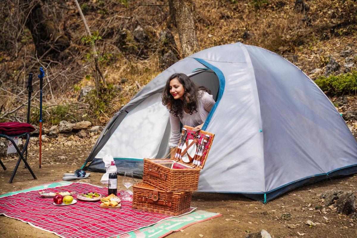 a woman standing in a tent with a basket in front at The Westin Resort & Spa Himalayas in Rishīkesh