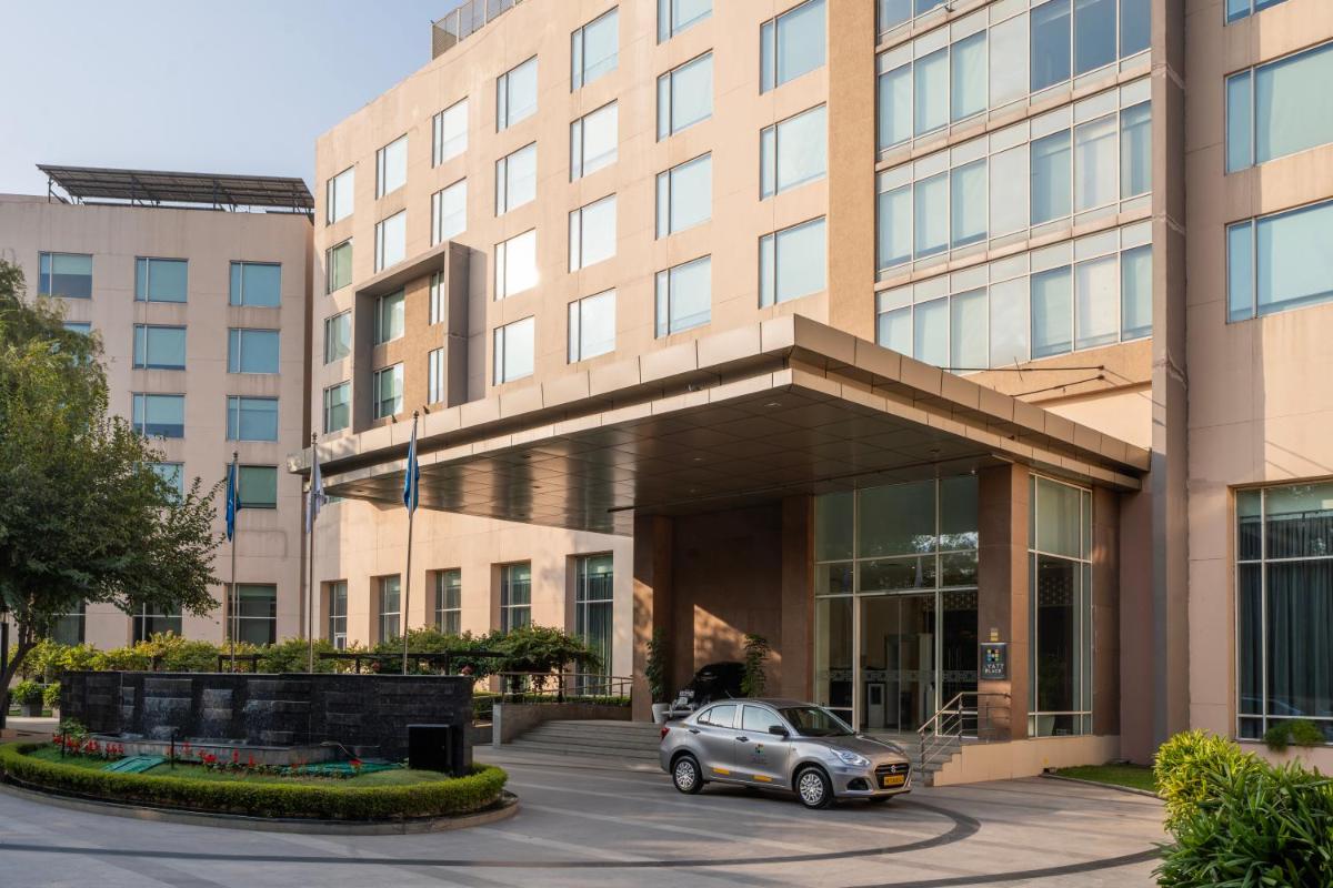 a car parked in front of a building at Hyatt Place Gurgaon Udyog Vihar in Gurgaon