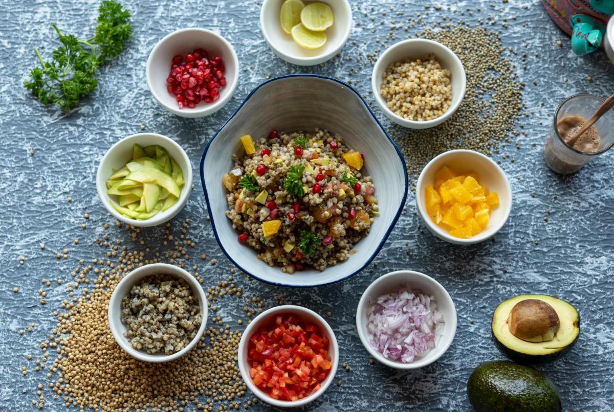a table topped with bowls of different types of food at Hyatt Place Gurgaon Udyog Vihar in Gurgaon
