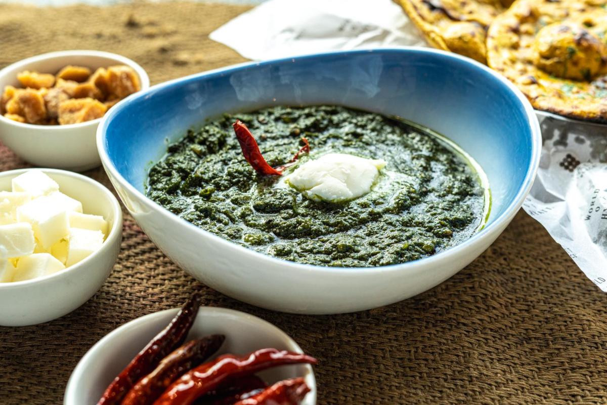 a bowl of soup with butter and other food on a table at Hyatt Place Gurgaon Udyog Vihar in Gurgaon