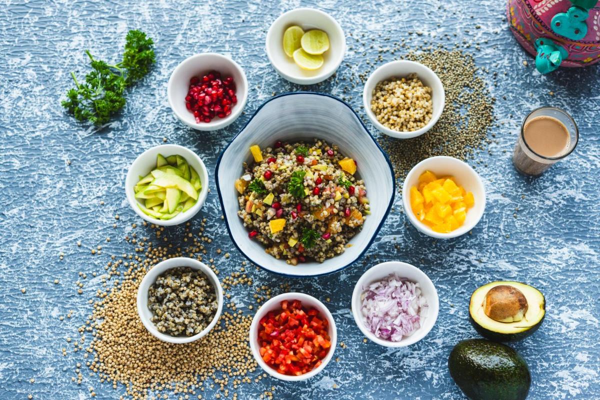 a table topped with bowls of different types of food at Hyatt Place Gurgaon Udyog Vihar in Gurgaon