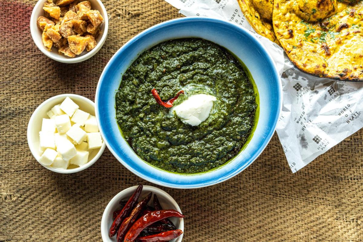a blue bowl of pesto with cheese and other food at Hyatt Place Gurgaon Udyog Vihar in Gurgaon