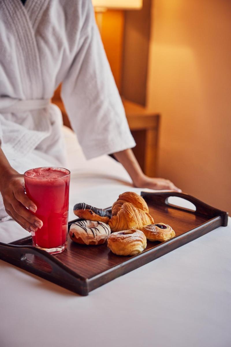 a tray of pastries and a drink on a table at Hyatt Place Gurgaon Udyog Vihar in Gurgaon