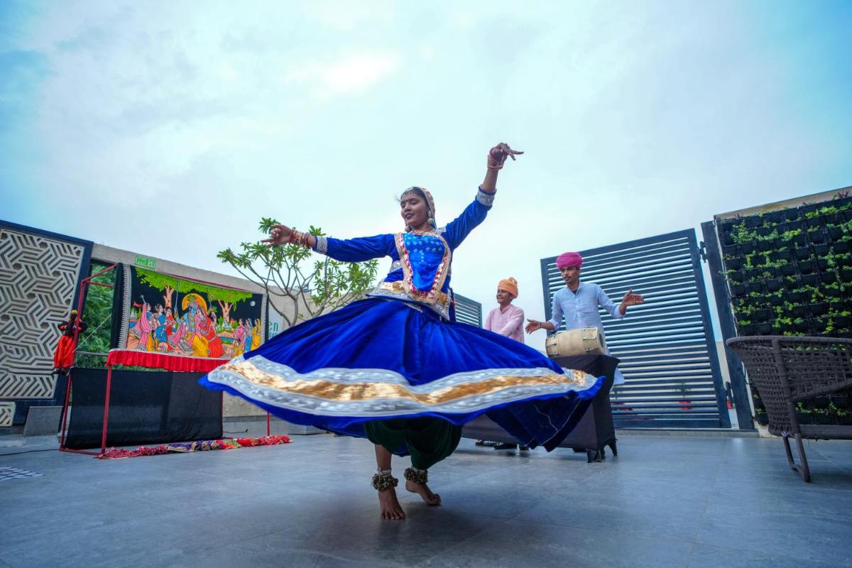 a woman in a blue dress dancing on a stage at DoubleTree By Hilton Jaipur Amer in Jaipur