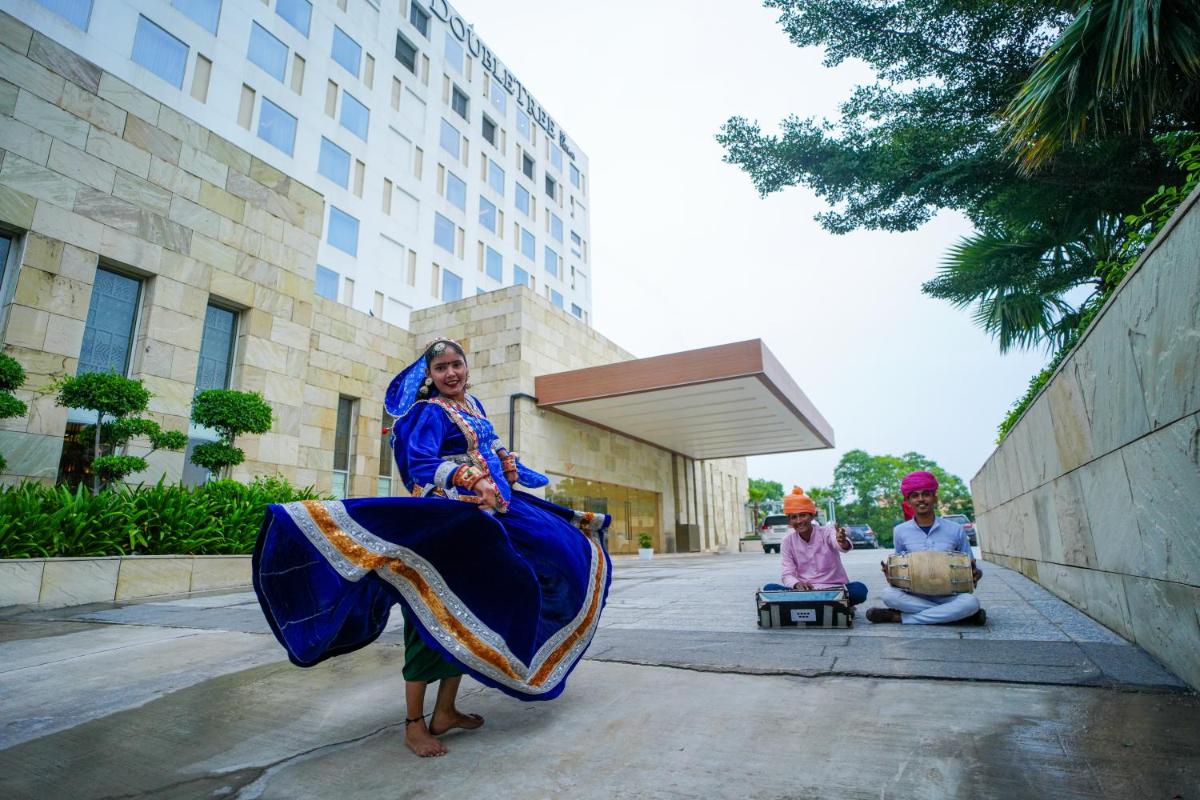 a group of people sitting in front of a building at DoubleTree By Hilton Jaipur Amer in Jaipur