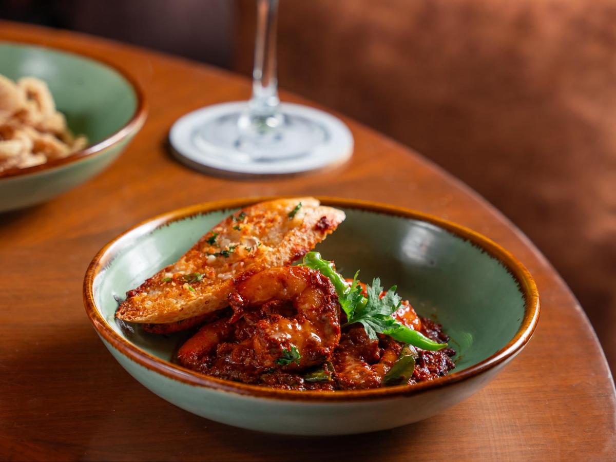 a bowl of food with meat on a table at Hyatt Pune in Pune