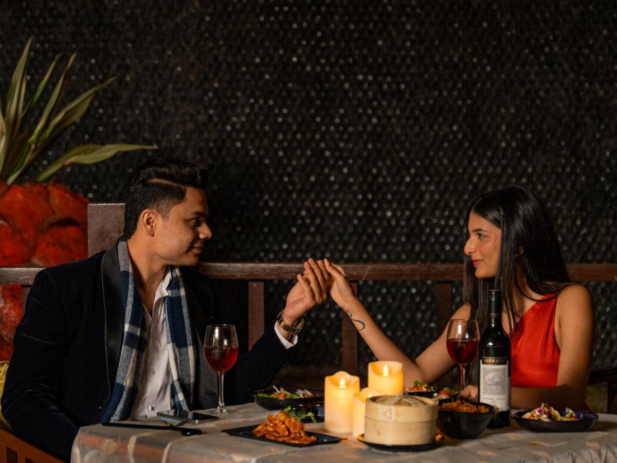 a man and a woman sitting at a table with wine glasses at Hyatt Pune in Pune