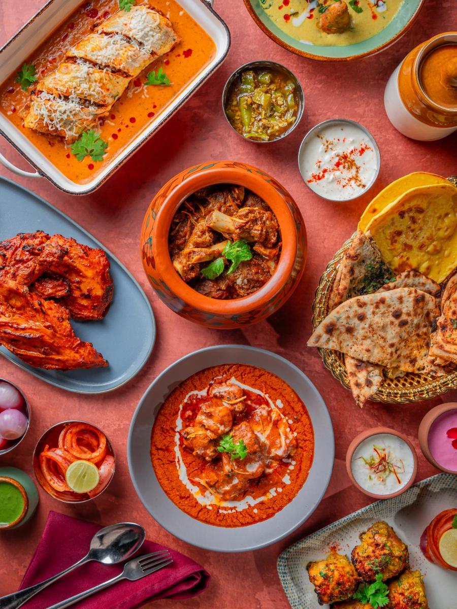 a table with many plates of food on it at Hyatt Pune in Pune