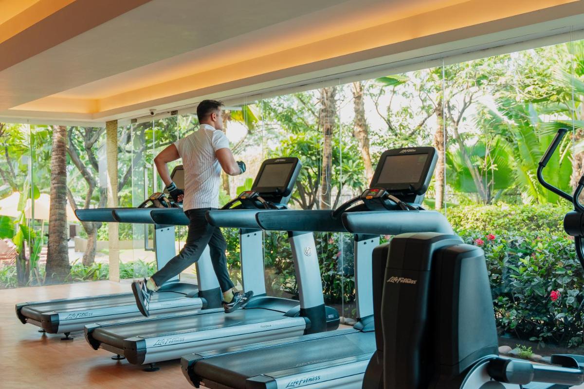 a man walking on a treadmill in a gym at Hyatt Pune in Pune