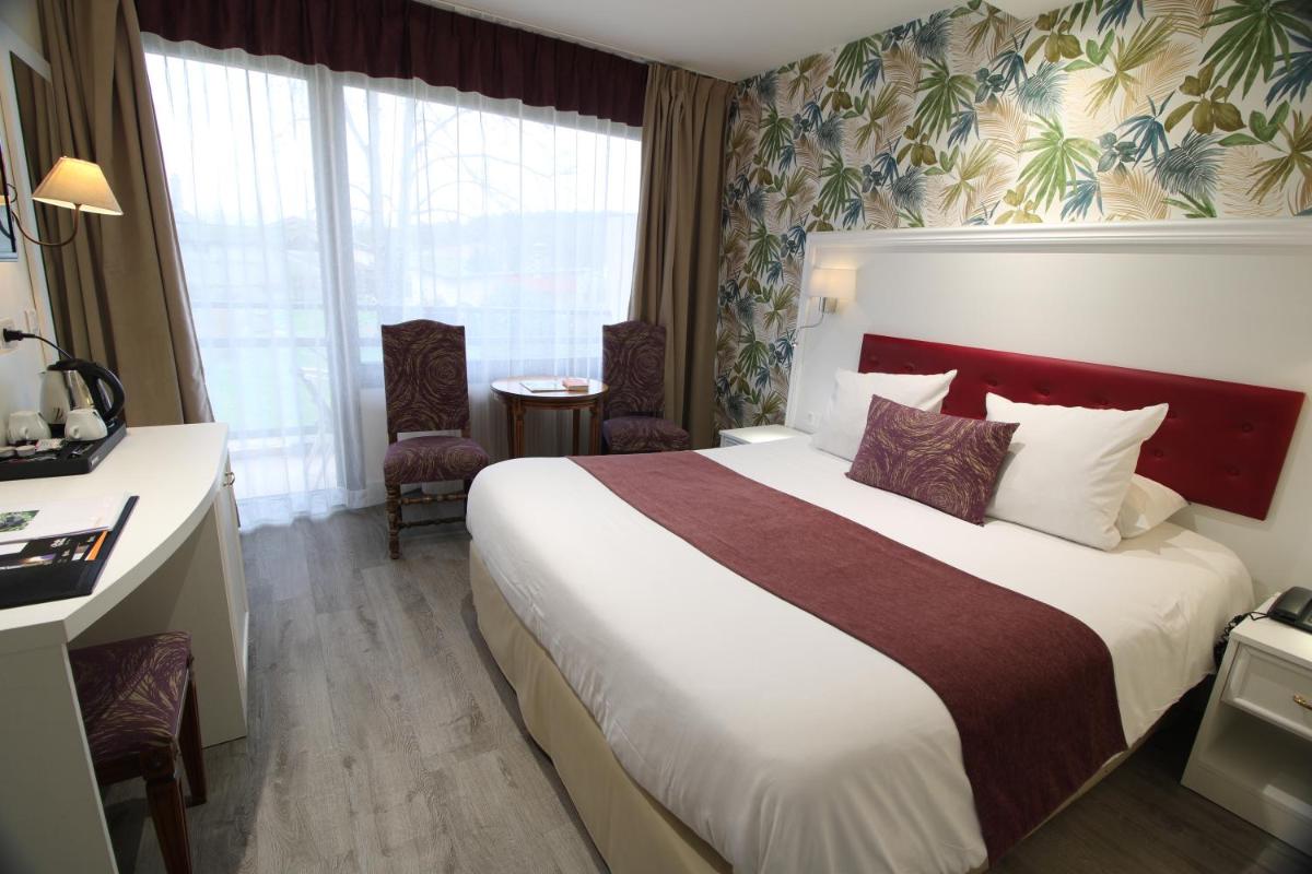 Un ou plusieurs lits dans un hébergement de l'établissement Le Moulin Du Landion Hôtel et Spa