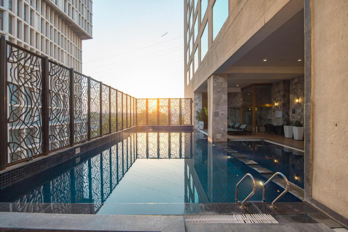 a swimming pool in the middle of a building at Novotel Ahmedabad in Ahmedabad
