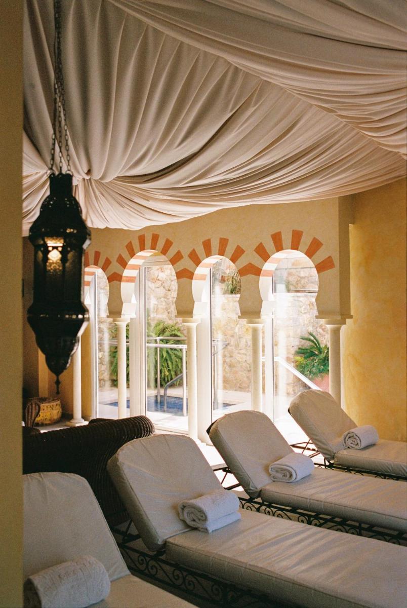 Habitación con 4 camas blancas frente a una ventana en Hotel Bon Sol Resort & Spa, en Illetas