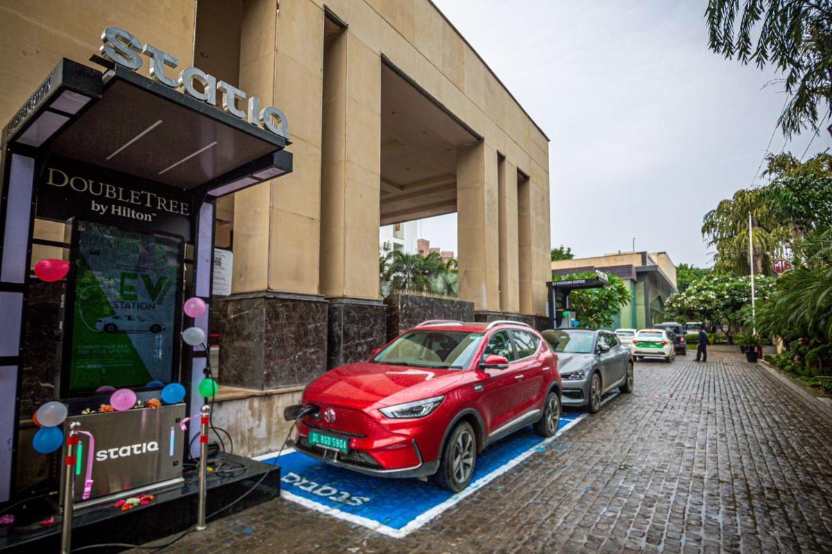 a red car parked in front of a building at DoubleTree by Hilton Gurgaon New Delhi NCR in Gurgaon
