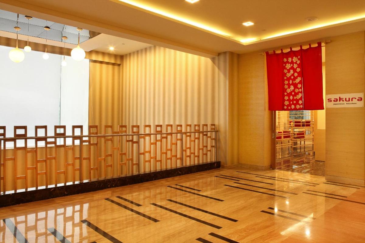 a room with a red curtain at The Metropolitan Hotel & Spa New Delhi in New Delhi