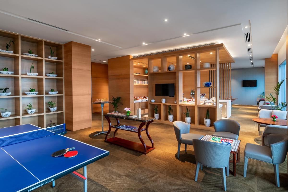 a room with a ping pong table and chairs at Hyatt Regency Lucknow Gomti Nagar in Lucknow