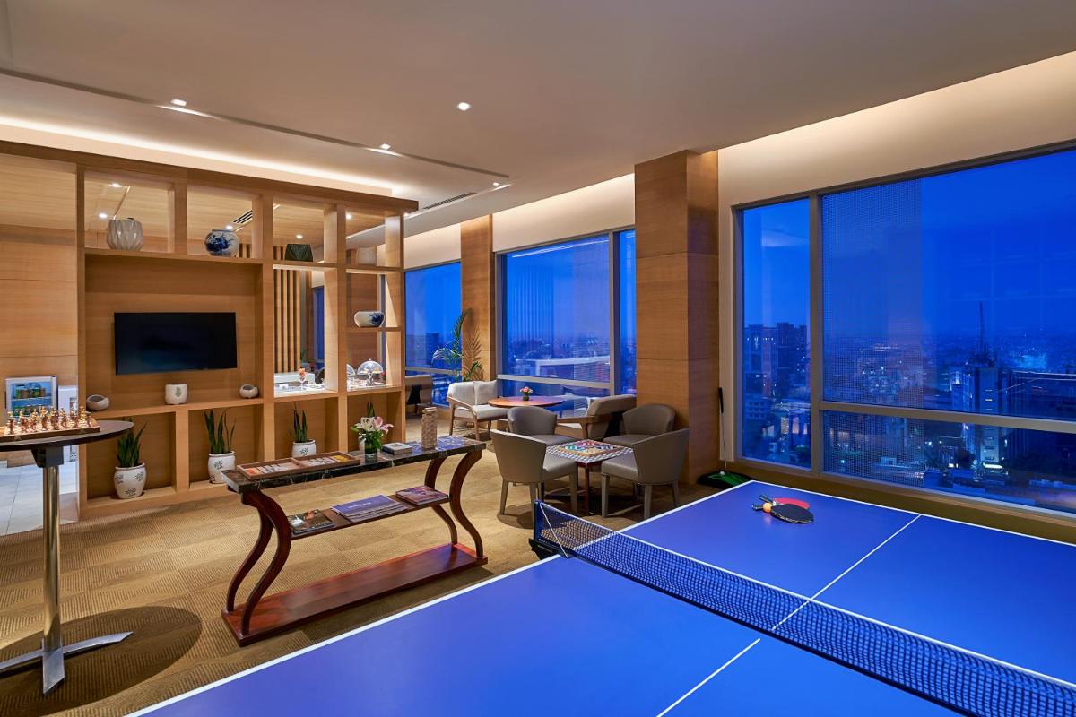 a living room with a blue ping pong table at Hyatt Regency Lucknow Gomti Nagar in Lucknow
