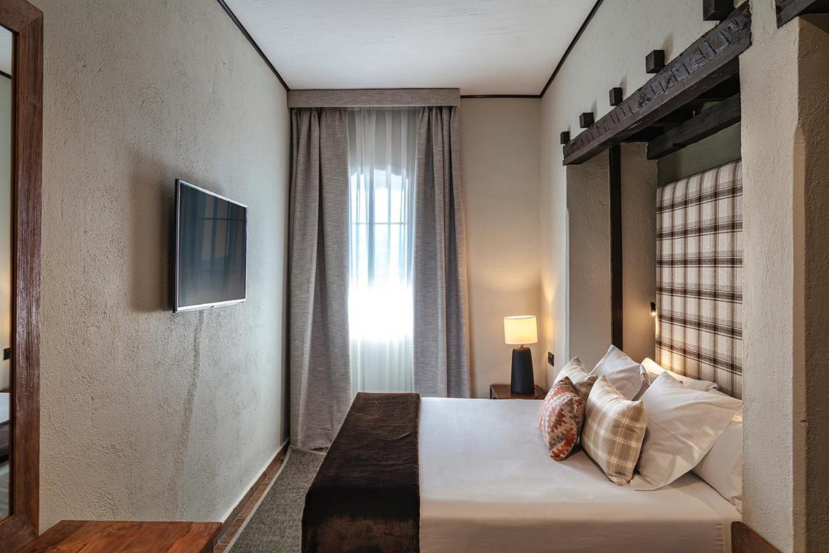 Cama o camas de una habitación en Vincci Selección Rumaykiyya