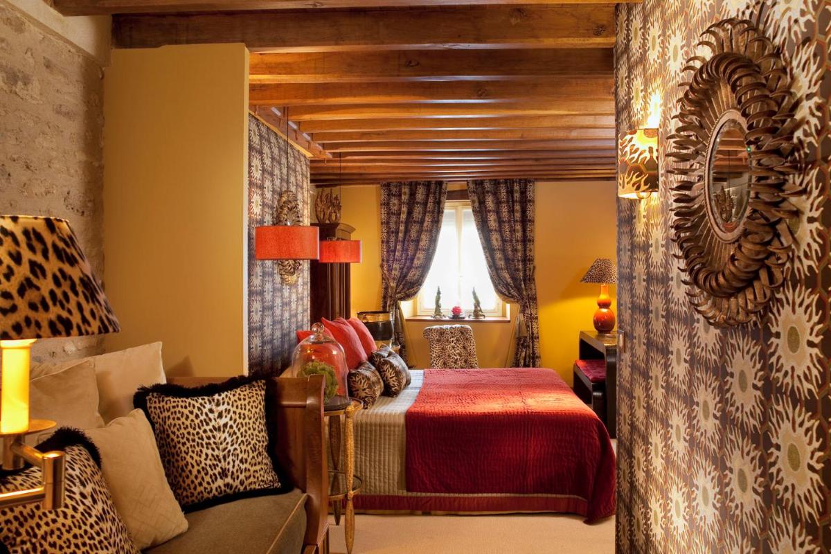 Un ou plusieurs lits dans un hébergement de l'établissement Hotel De France