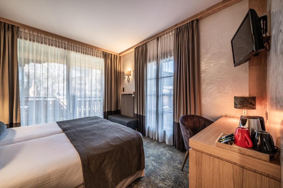 Un ou plusieurs lits dans un hébergement de l'établissement Hotel Le Samoyede