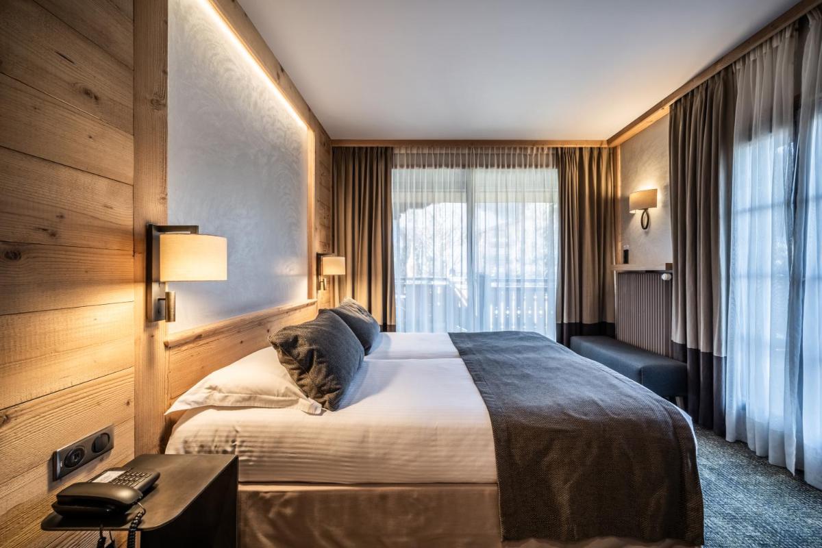 Un ou plusieurs lits dans un hébergement de l'établissement Hotel Le Samoyede