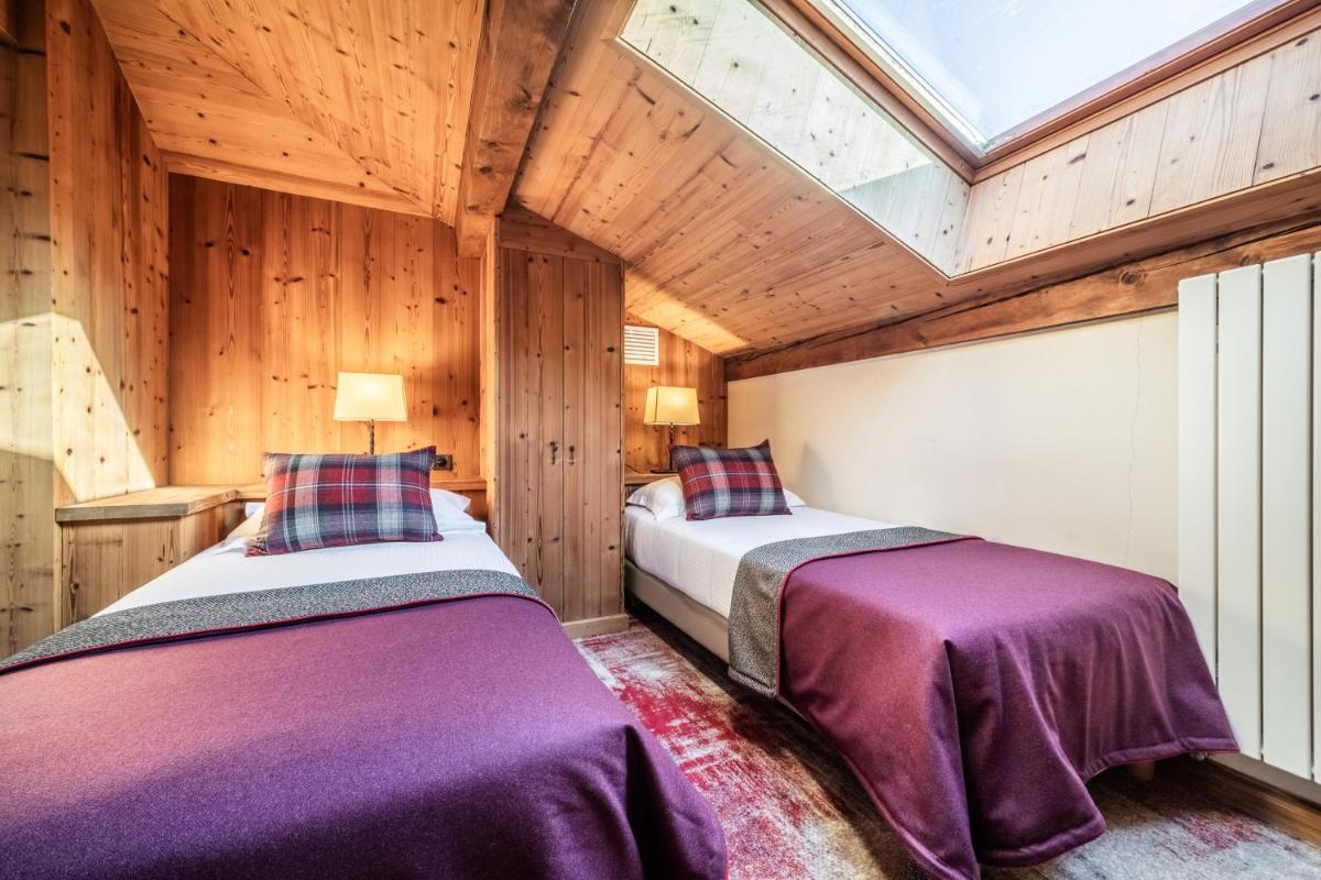 Un ou plusieurs lits dans un hébergement de l'établissement Hotel Le Samoyede