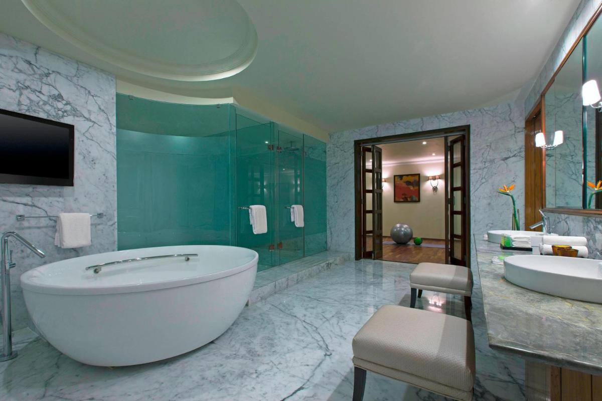 a large bathroom with a tub and a sink at The Westin Pune Koregaon Park in Pune