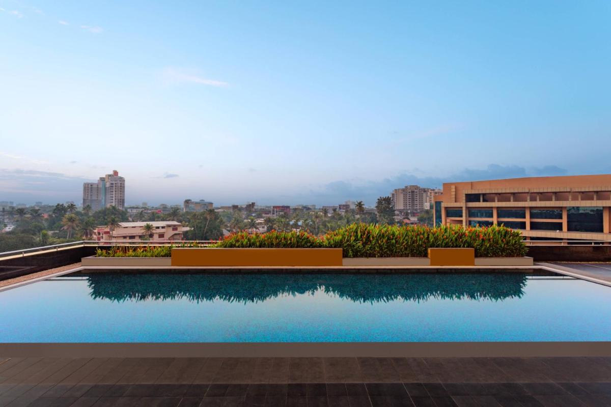 a swimming pool on the roof of a building at Kochi Marriott Hotel in Cochin