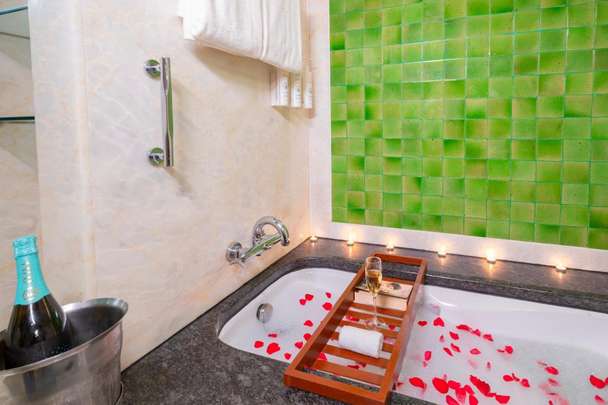 a bathroom with a bath tub with red hearts on it at Hyderabad Marriott Hotel & Convention Centre in Hyderabad