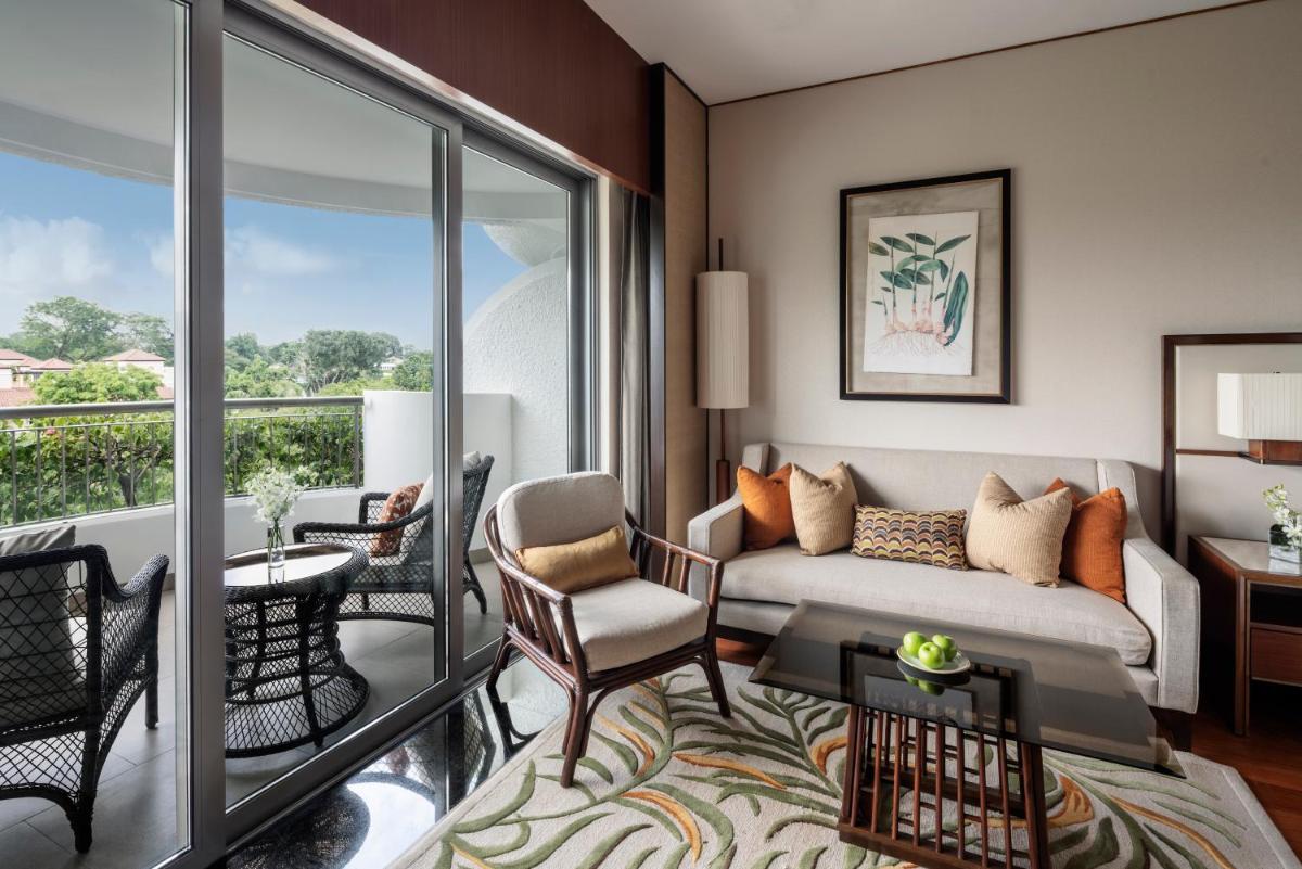 a living room with a couch and a balcony at Shangri-La Singapore in Singapore
