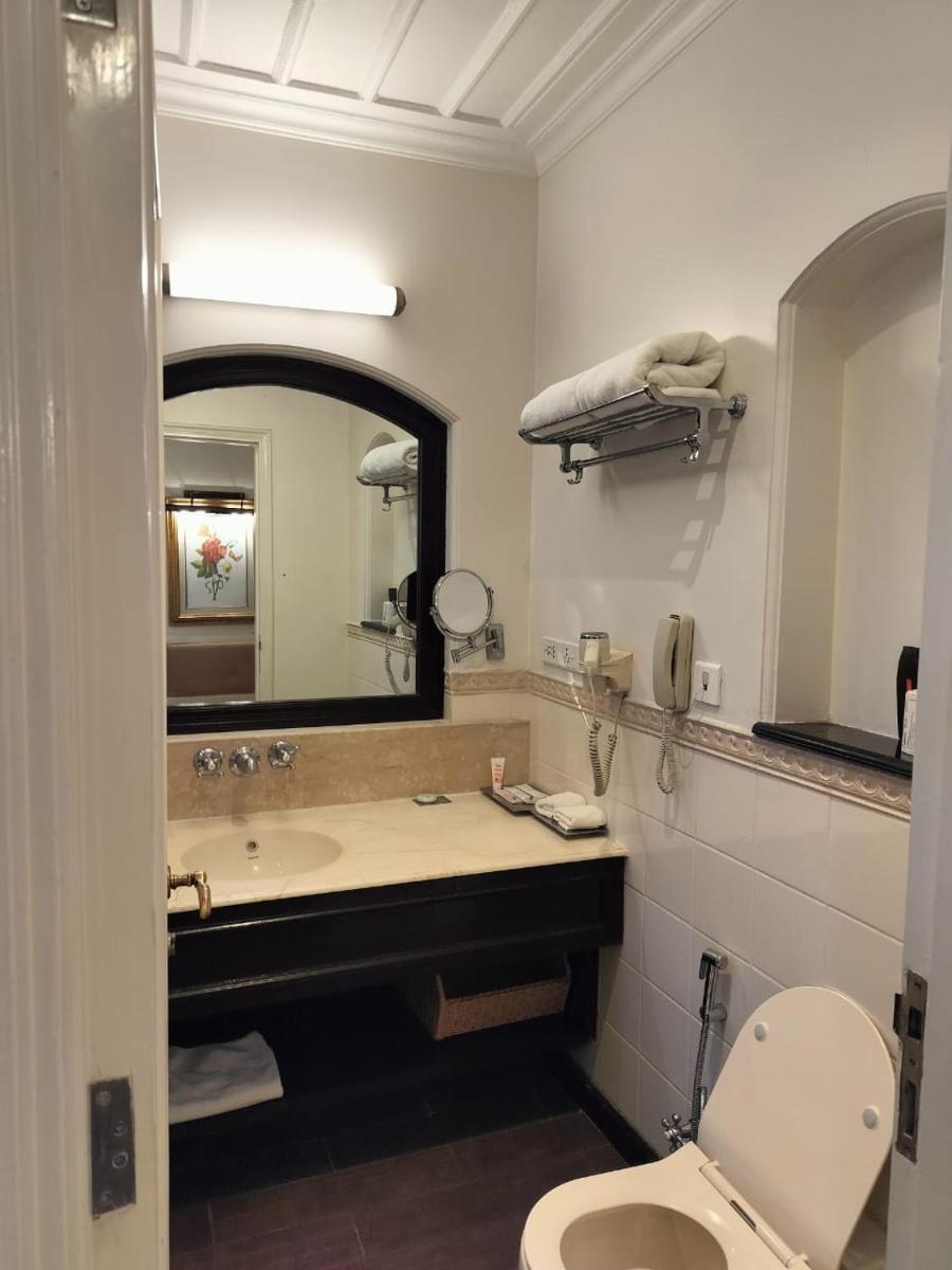 a bathroom with a sink and a toilet and a mirror at Welcomhotel by ITC Hotels, The Savoy, Mussoorie in Mussoorie