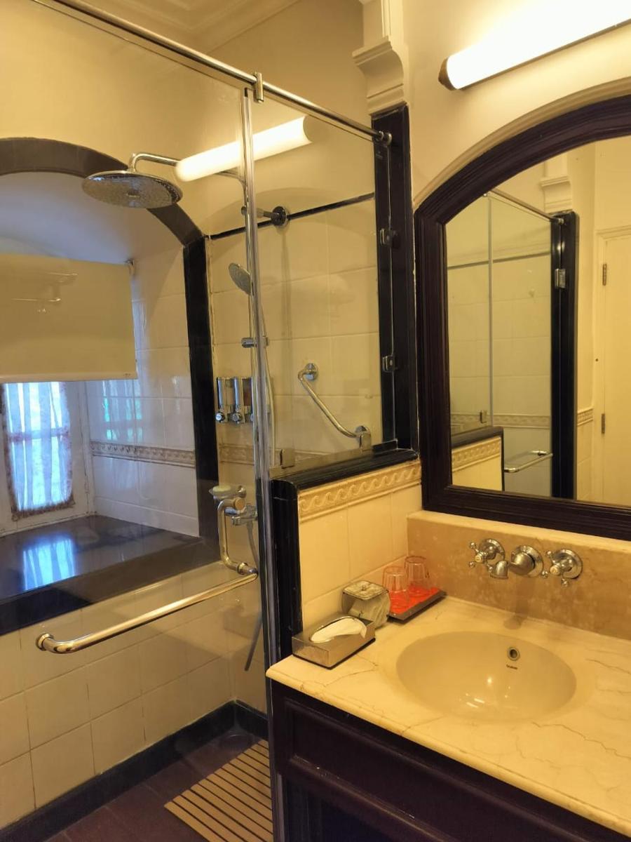 a bathroom with a sink and a shower with a mirror at Welcomhotel by ITC Hotels, The Savoy, Mussoorie in Mussoorie