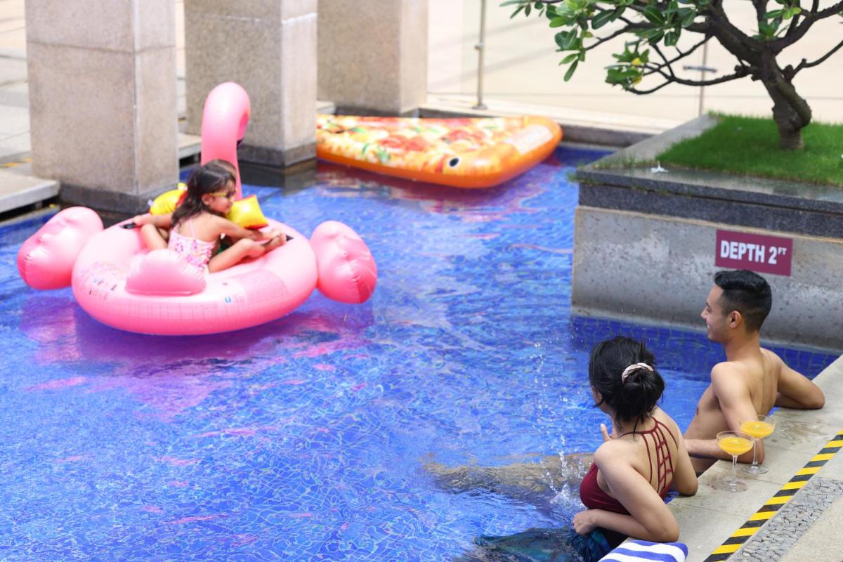a group of children playing in a water park at Novotel Hyderabad Airport in Hyderabad