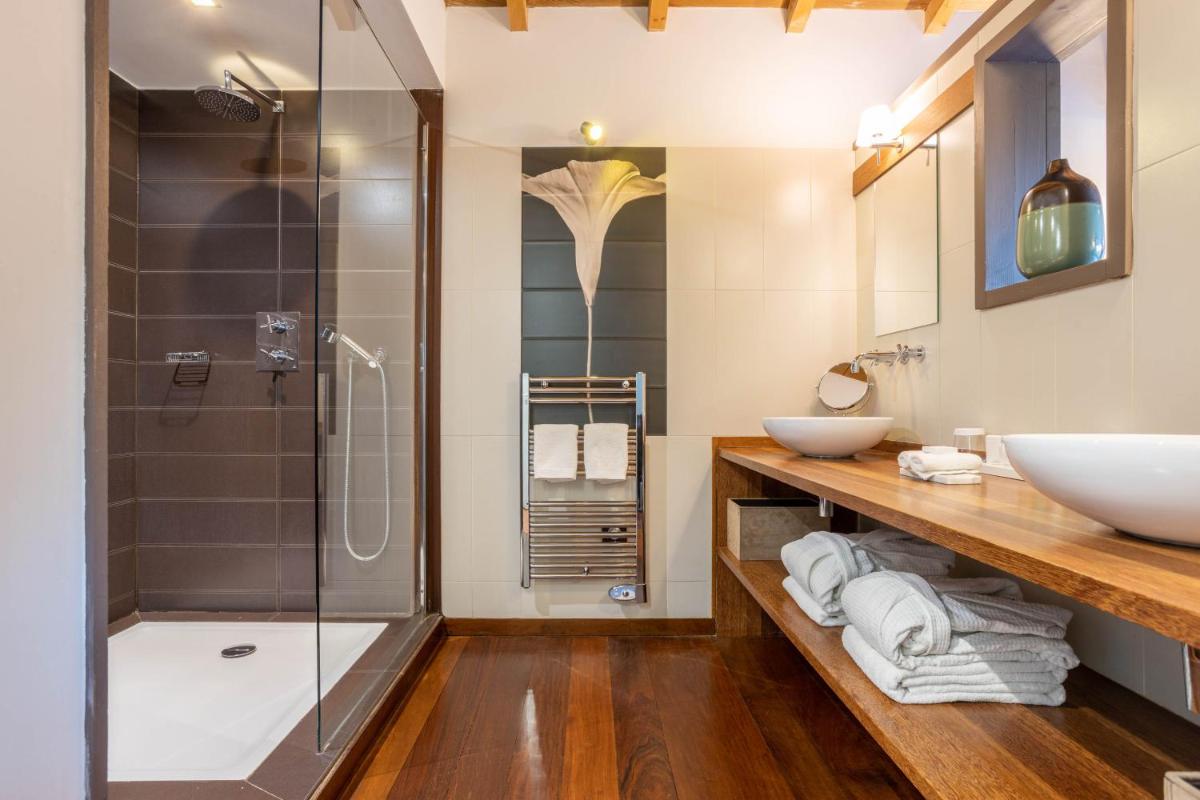 une salle de bain avec deux lavabos et une douche dans l'établissement Hôtel Côté Sable, à Cap-Ferret