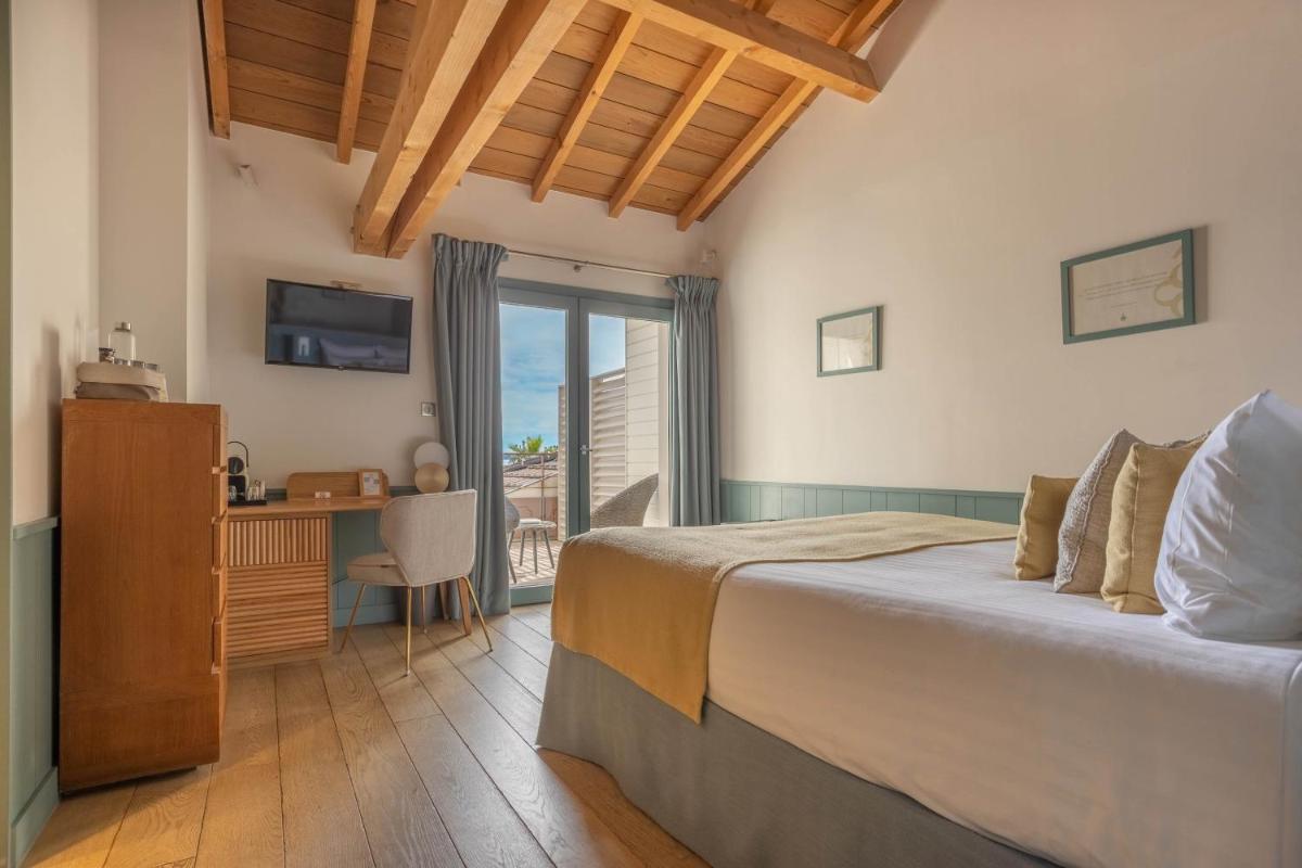 Un ou plusieurs lits dans un hébergement de l'établissement Hôtel Côté Sable