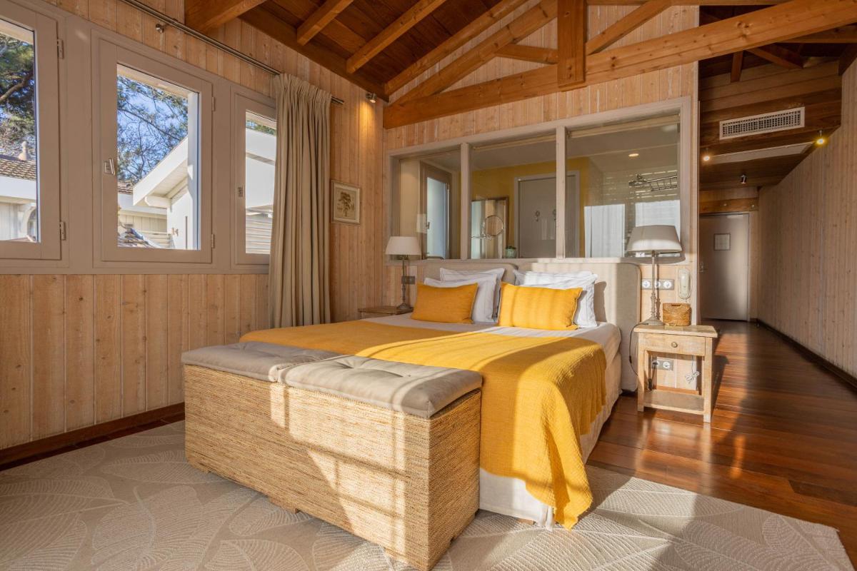 Un ou plusieurs lits dans un hébergement de l'établissement Hôtel Côté Sable