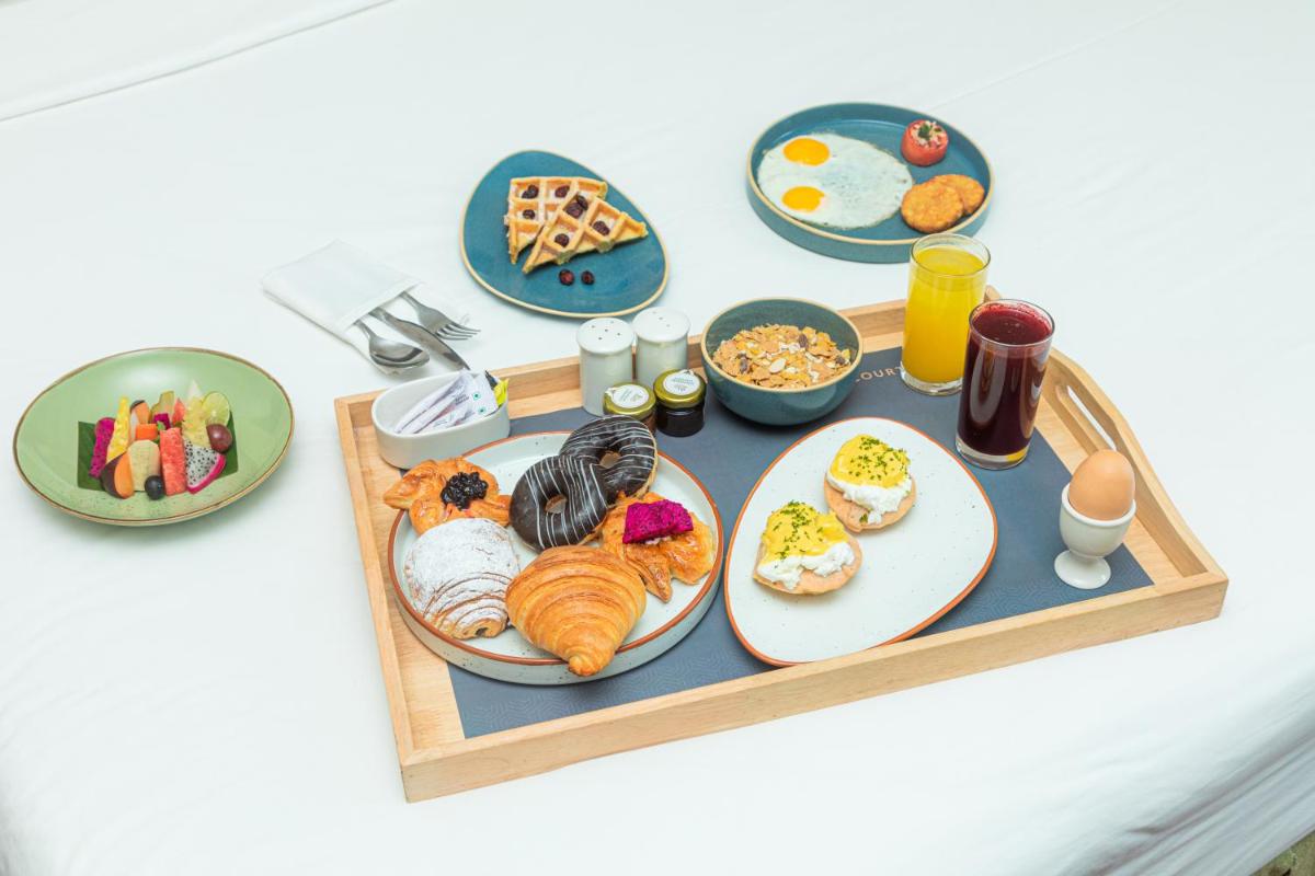 a tray filled with breakfast foods on a table at Hyderabad Marriott Hotel & Convention Centre in Hyderabad