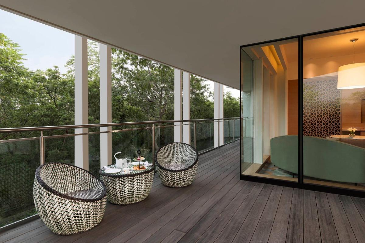 a balcony with three chairs and a table on it at InterContinental Jaipur Tonk Road by IHG in Jaipur