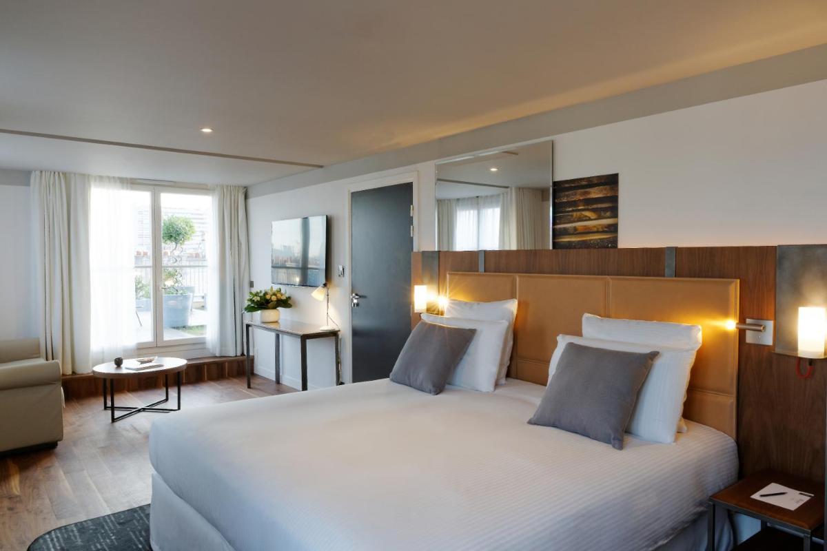 Un ou plusieurs lits dans un hébergement de l'établissement Boutet Bastille Hotel Paris - MGallery Collection
