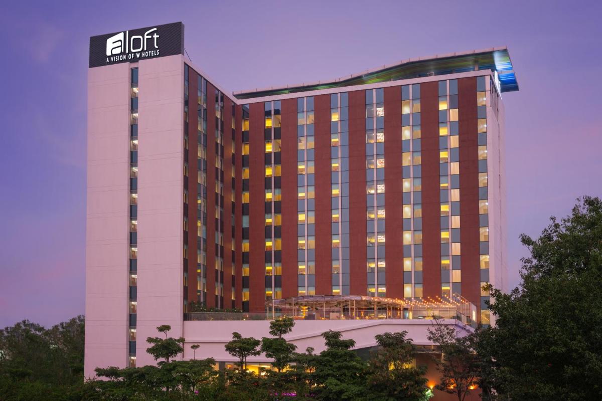 a hotel building with a sign on top of it at Aloft Bengaluru Outer Ring Road in Bengaluru