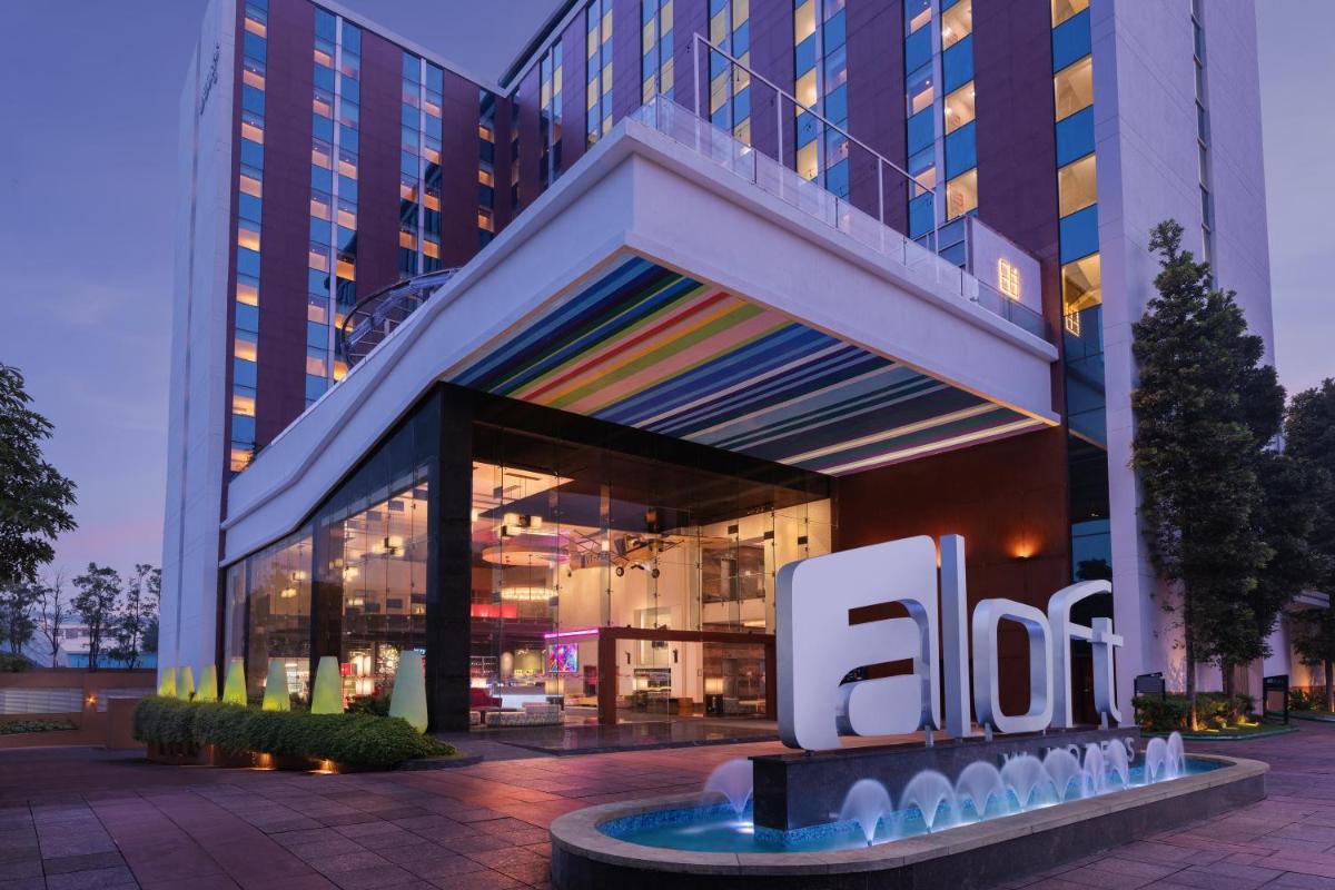an office building with a sign in front of it at Aloft Bengaluru Outer Ring Road in Bengaluru an office building with a sign in front of it at Aloft Bengaluru Outer Ring Road in Bengaluru