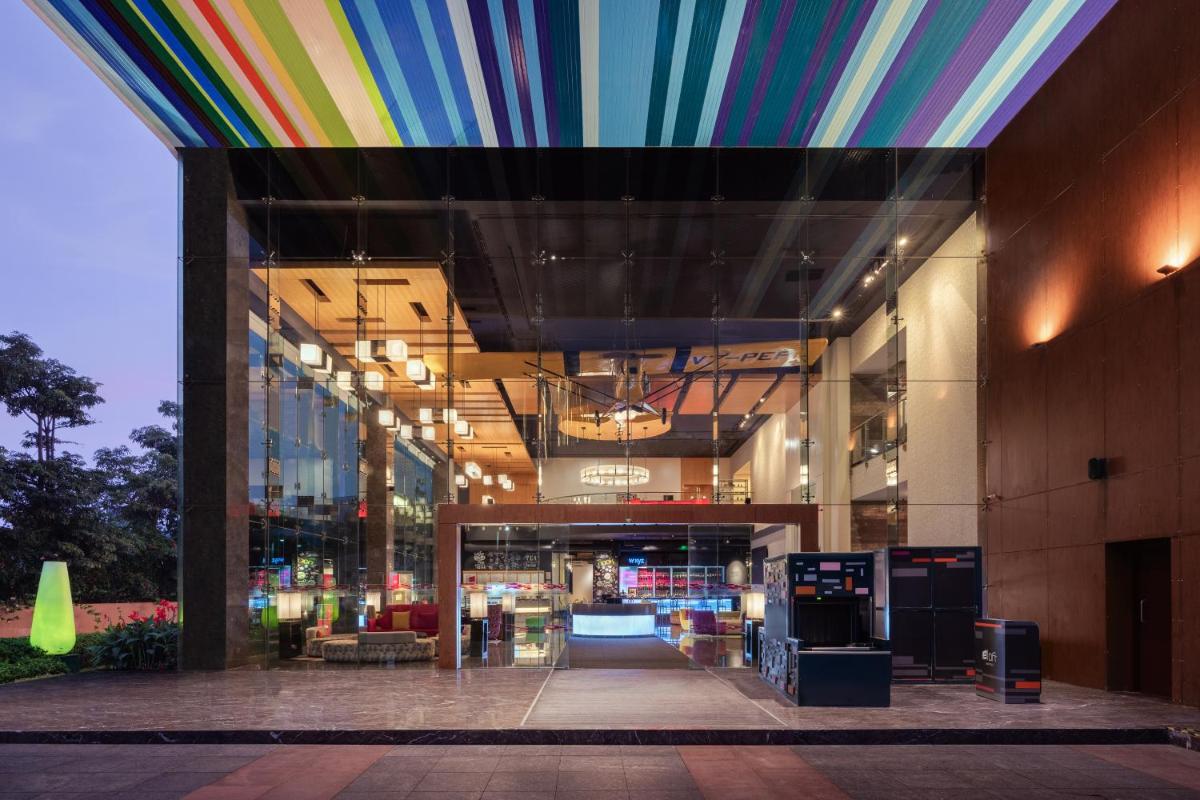 a colorful ceiling in a building with a lobby at Aloft Bengaluru Outer Ring Road in Bengaluru