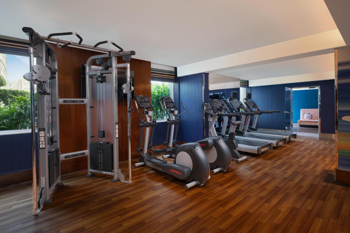 a gym with treadmills and elliptical machines at Aloft Bengaluru Outer Ring Road in Bengaluru