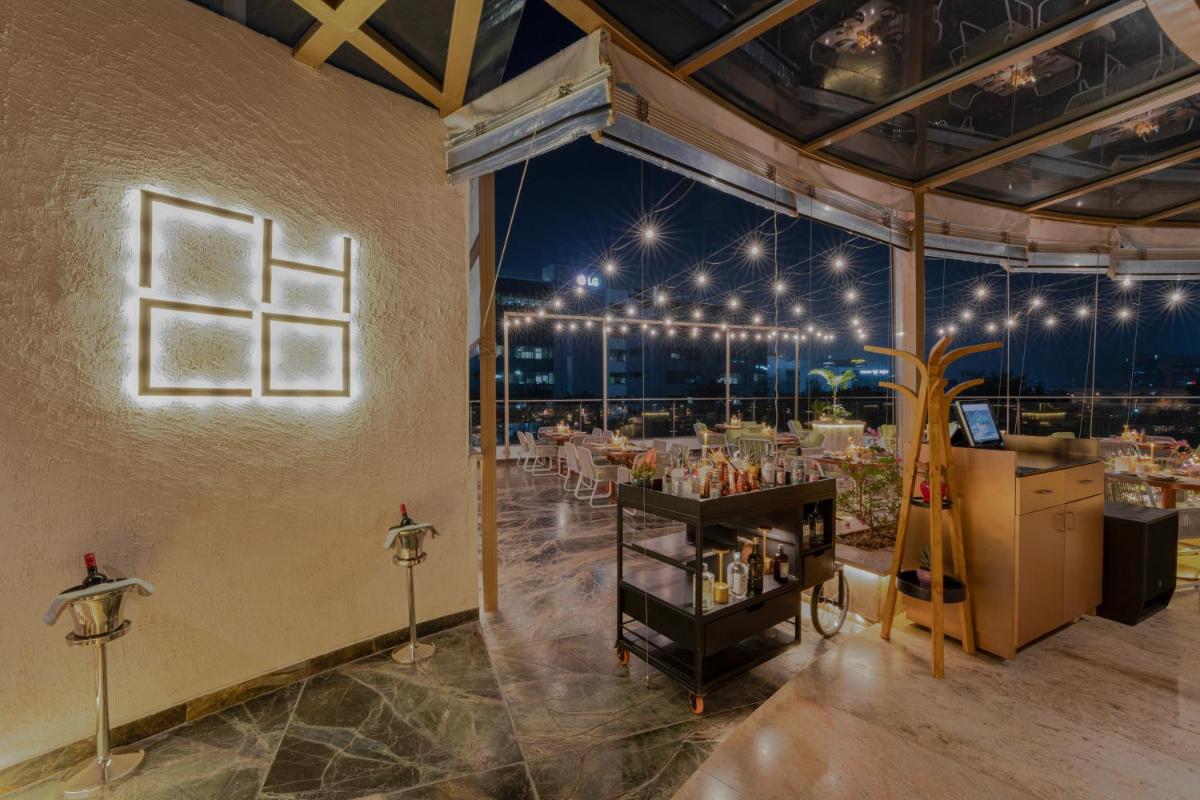 a large room with a tables and chairs in it at Aloft Bengaluru Outer Ring Road in Bengaluru