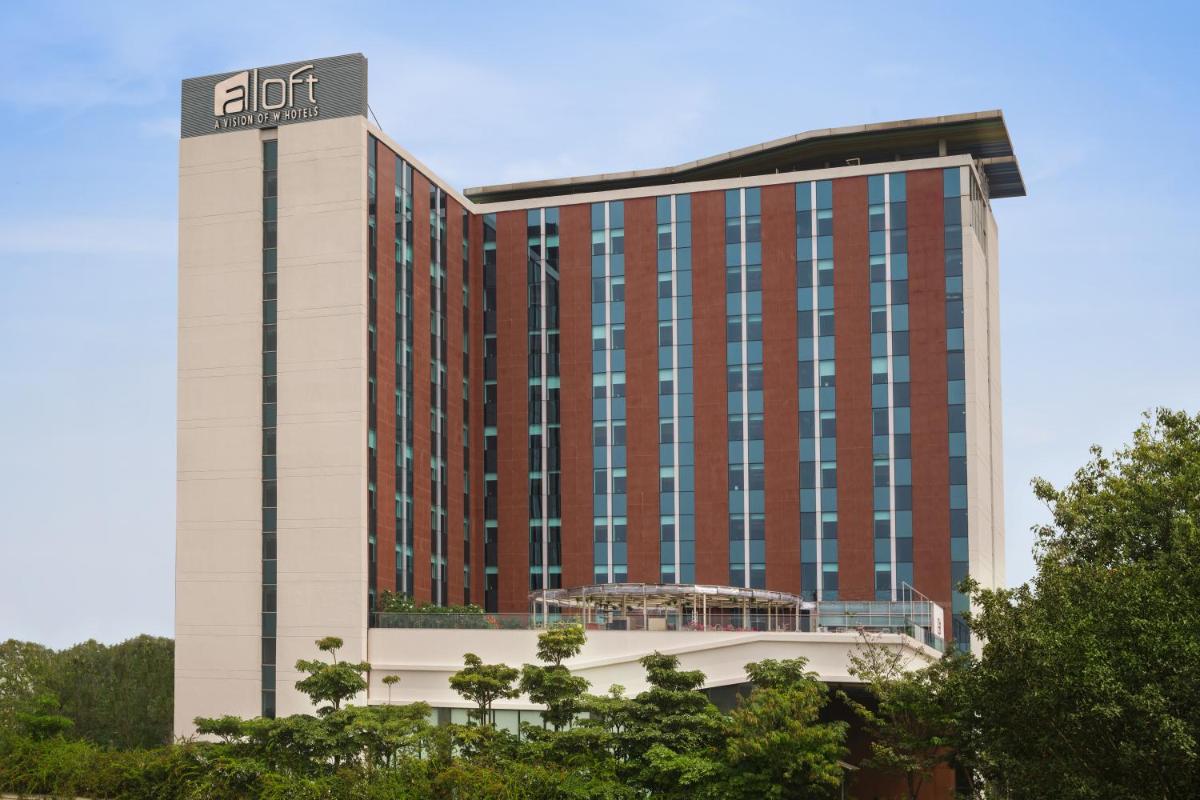 a hotel building with a sign on top of it at Aloft Bengaluru Outer Ring Road in Bengaluru