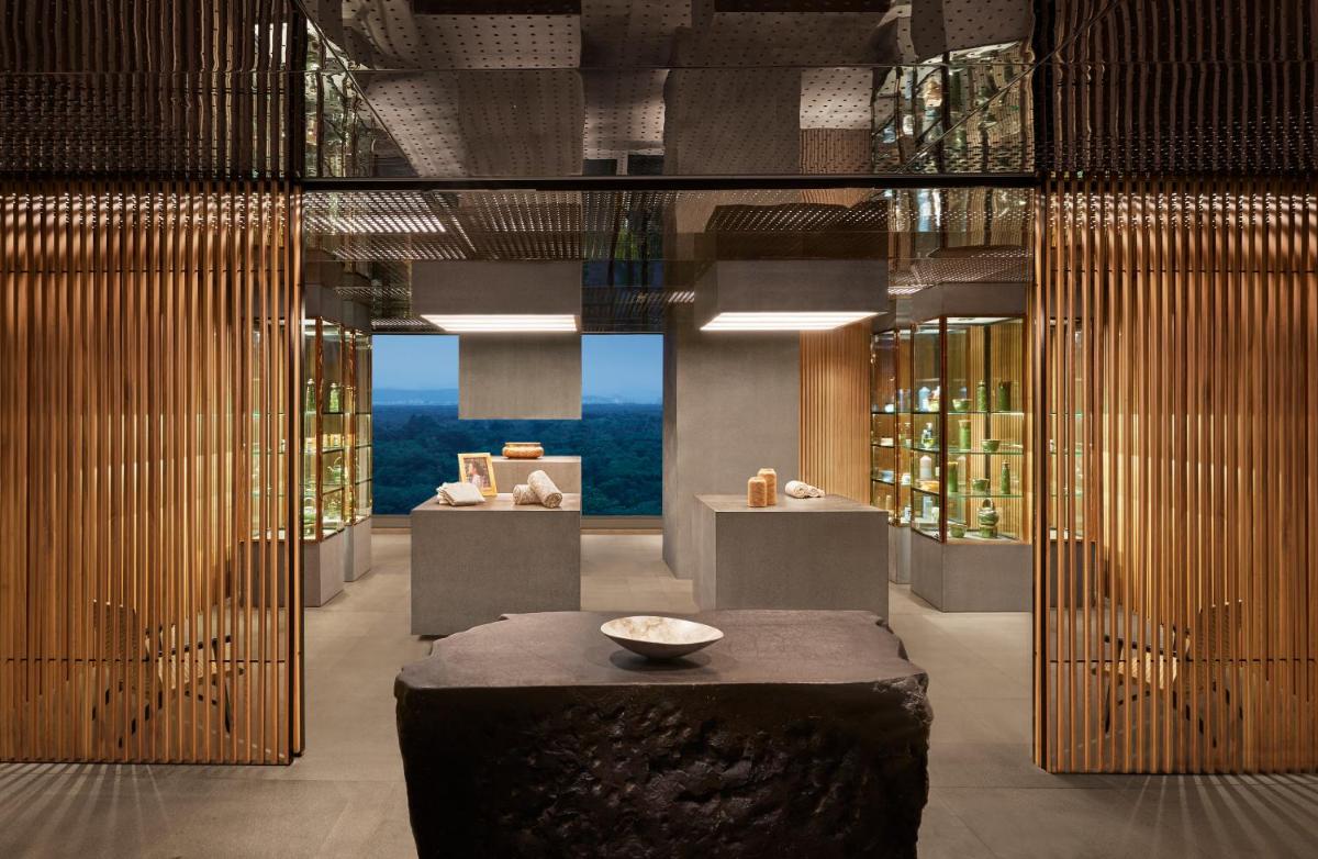 a lobby with a table and a room with bottles at Taj The Trees, Mumbai in Mumbai
