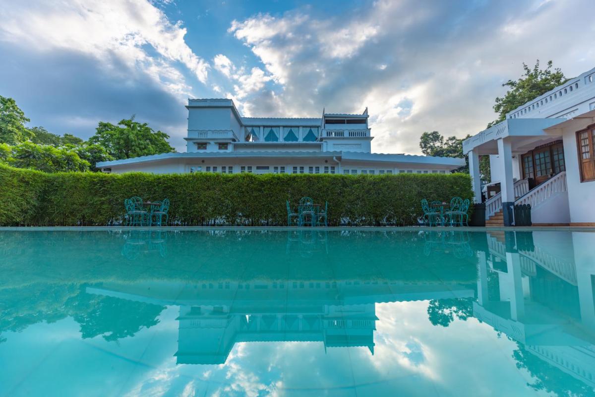 a house with a pool in front of a building at Saraca Hotel Lucknow in Lucknow